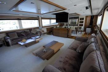 a living room with a couch and a coffee table aboard STEEL Yacht for Charter