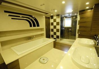 a bathroom with a tub sink and a sink aboard STEEL Yacht for Charter