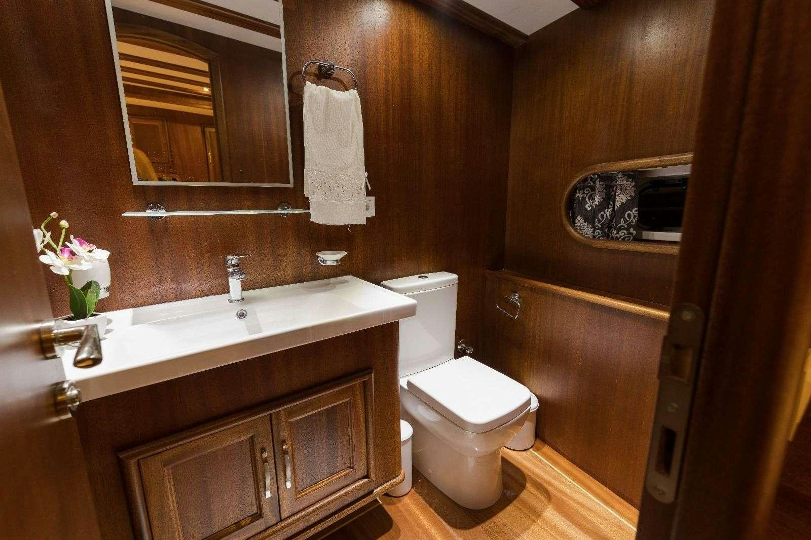 a bathroom with a toilet and sink aboard KORAY EGE Yacht for Charter