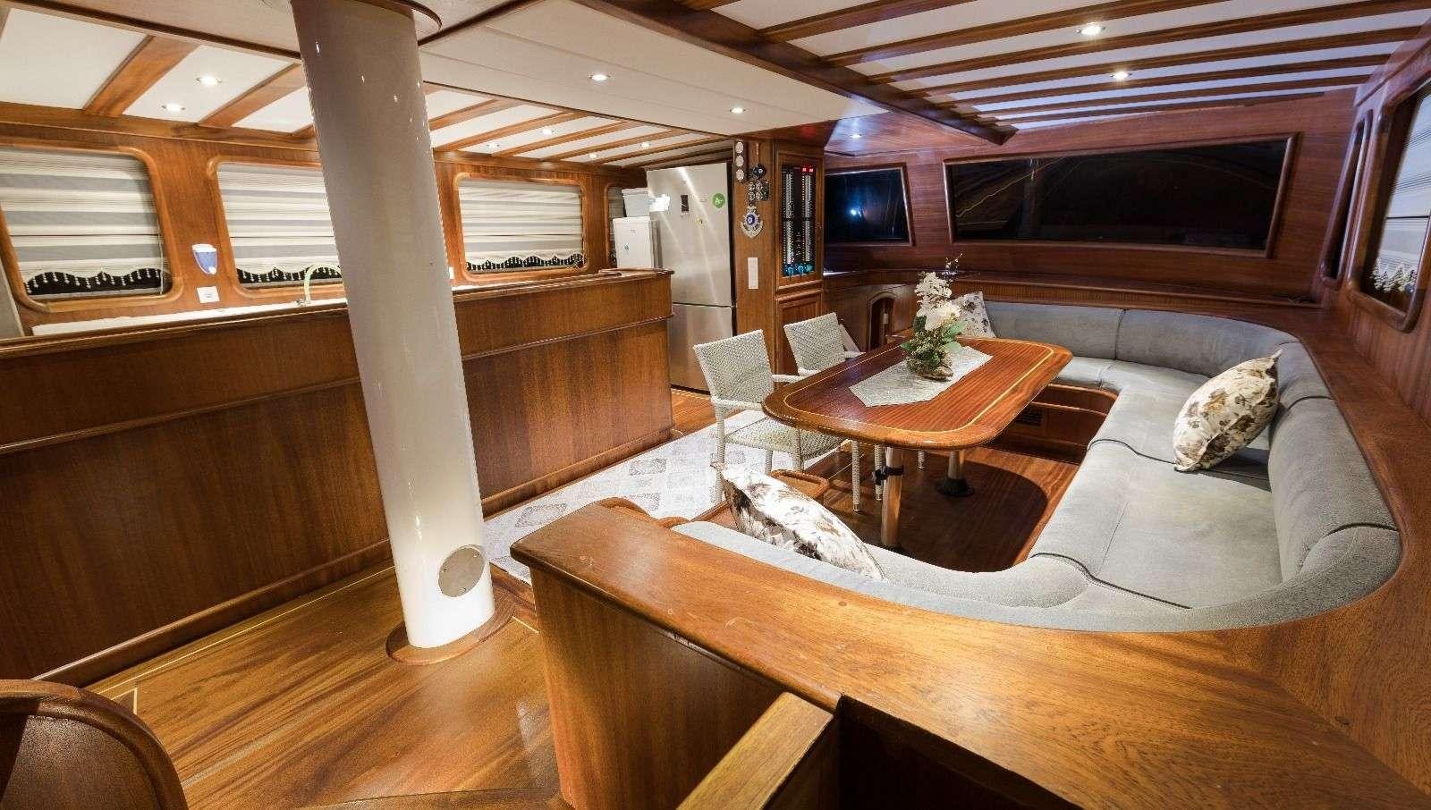 a living room with a couch and a table aboard KORAY EGE Yacht for Charter