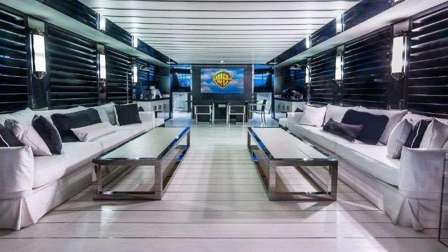 a room with a couch and a table and a television aboard DOUBLE SHOT Yacht for Charter