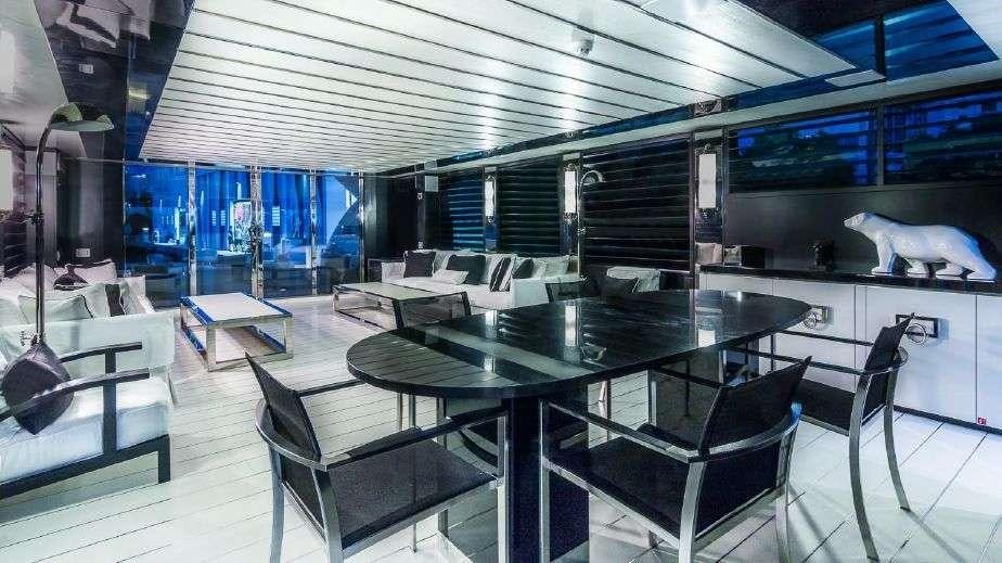a room with a table and chairs aboard DOUBLE SHOT Yacht for Charter