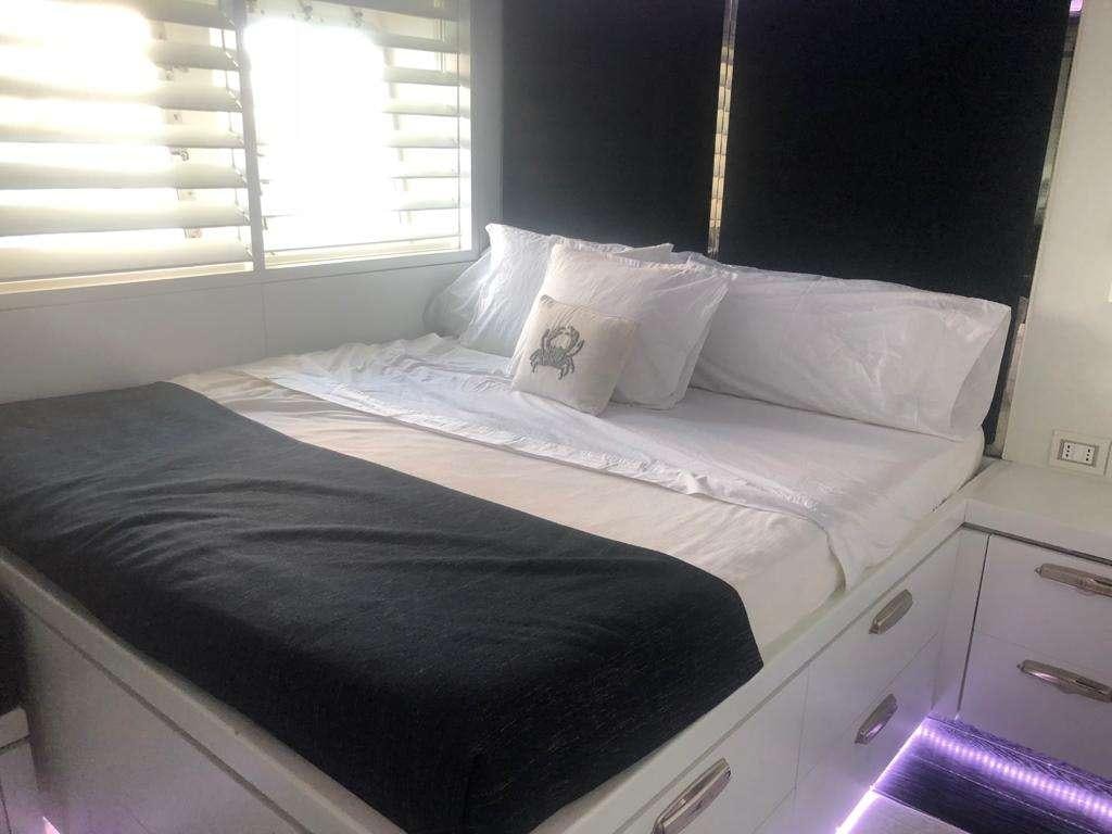 a bed with white sheets aboard DOUBLE SHOT Yacht for Charter