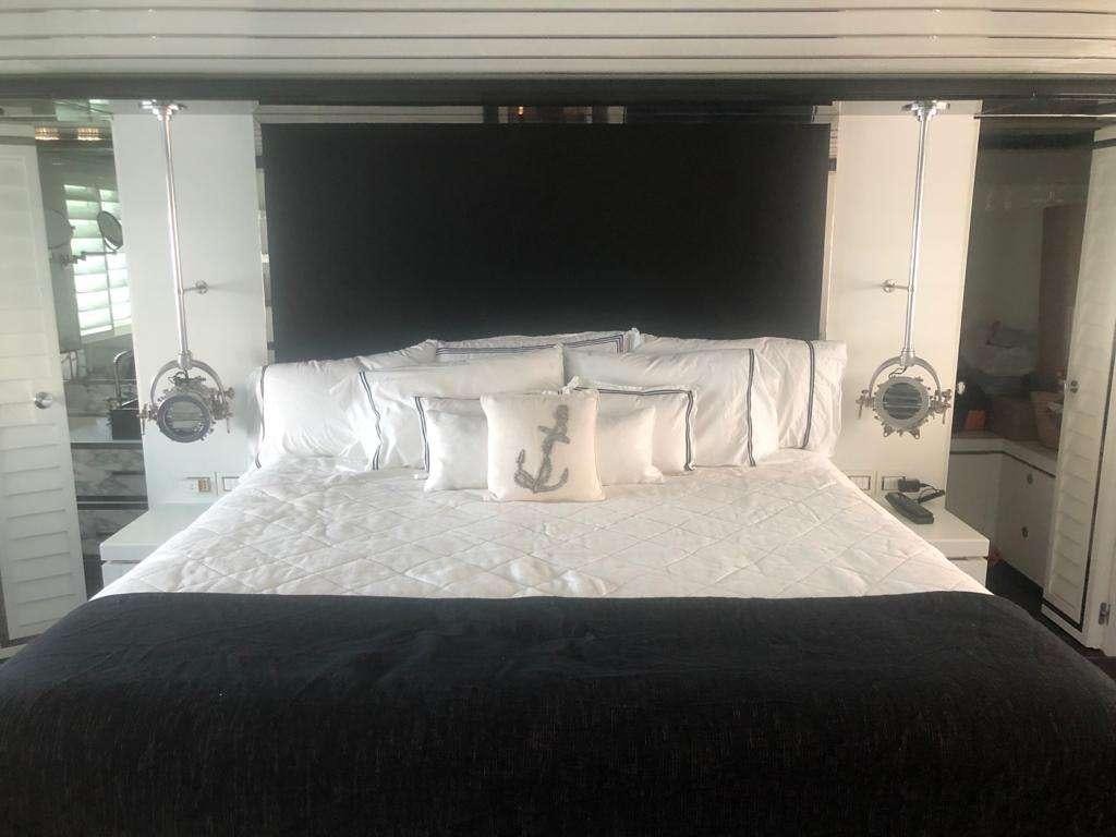a bed with white sheets aboard DOUBLE SHOT Yacht for Charter