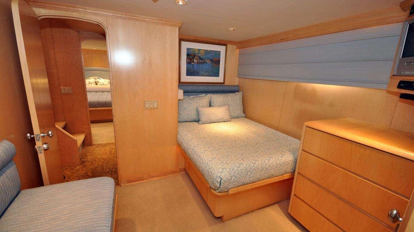 a room with a bed and a couch aboard LUCKY STARS Yacht for Charter