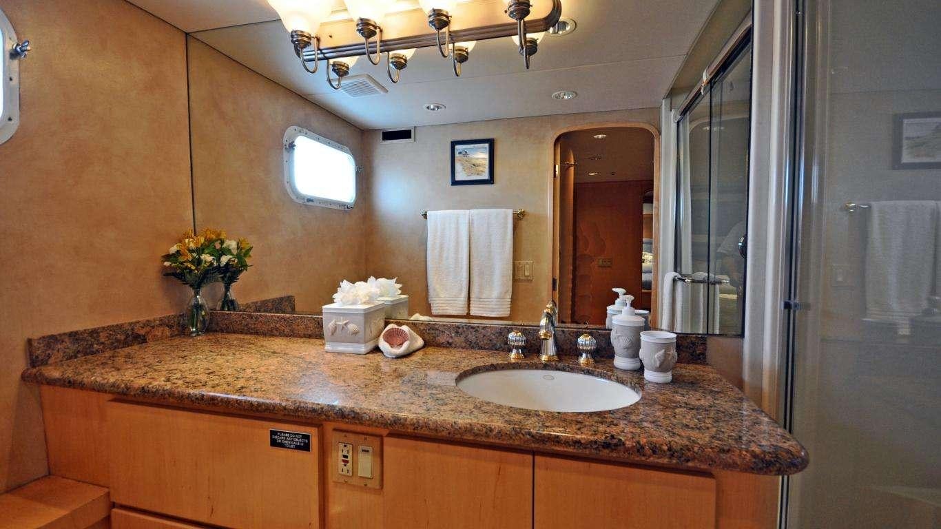 a bathroom with a countertop sink and mirror aboard LUCKY STARS Yacht for Charter