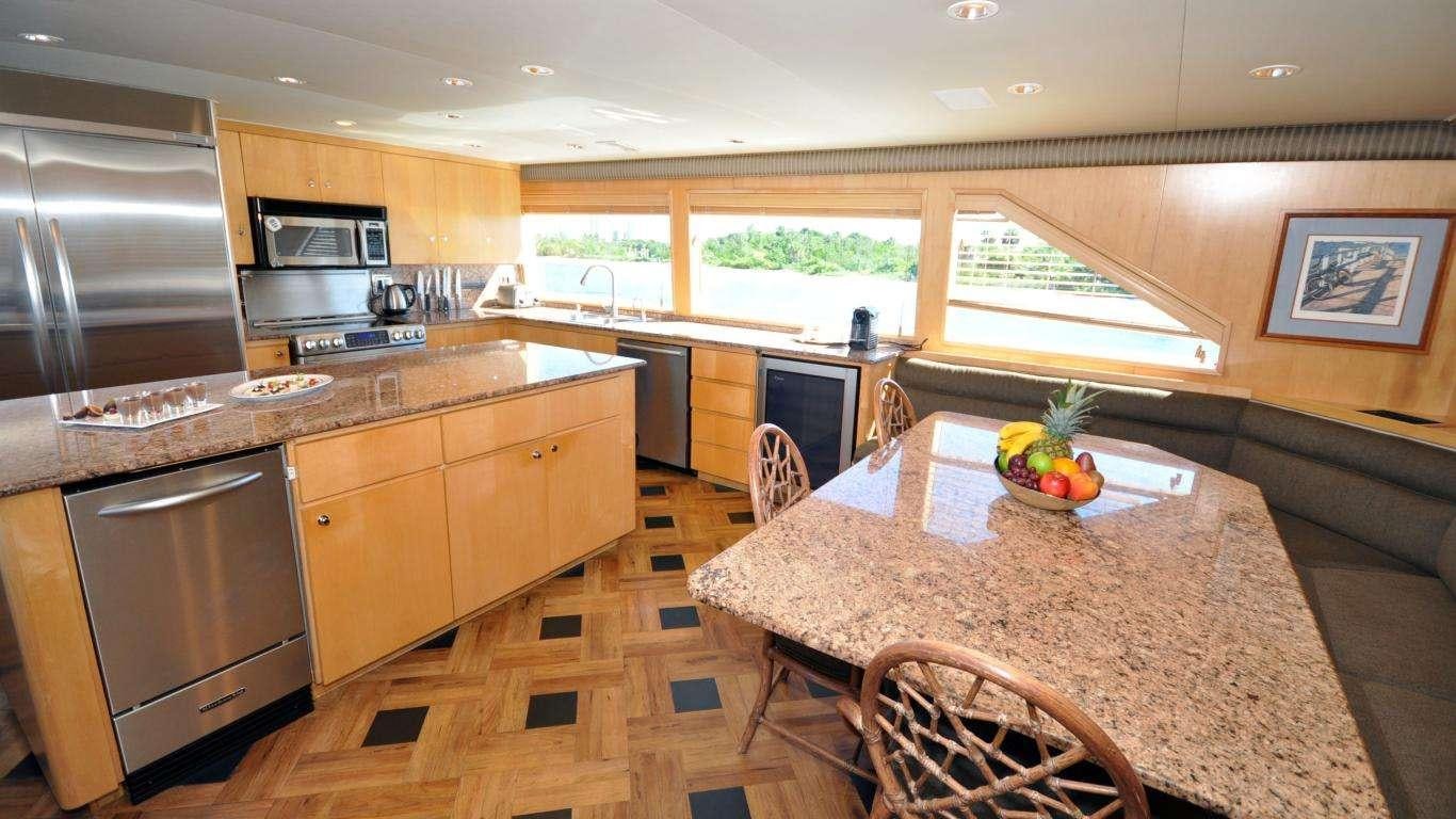 a kitchen with a table and chairs aboard LUCKY STARS Yacht for Charter