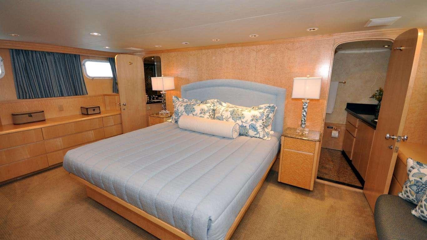 a bedroom with a bed and a desk aboard LUCKY STARS Yacht for Charter