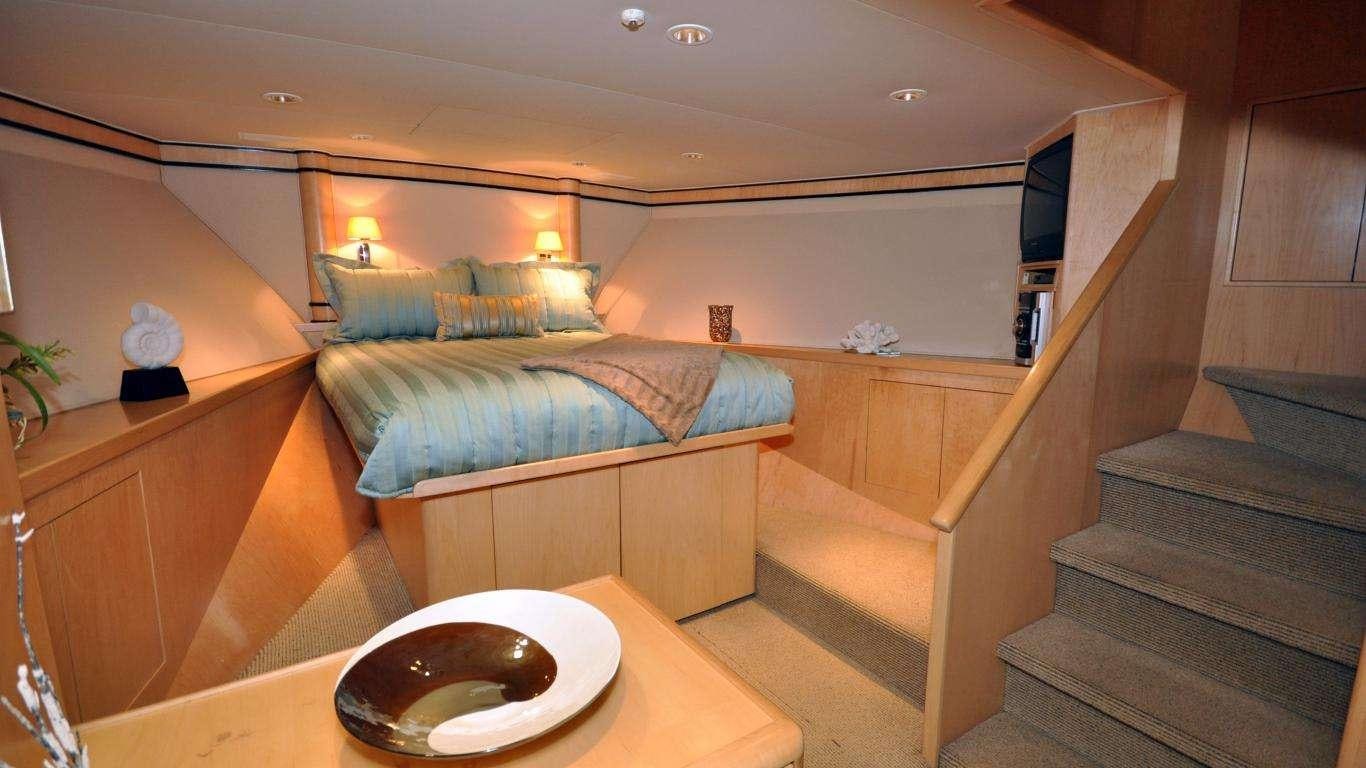 a bed and a table in a room aboard LUCKY STARS Yacht for Charter