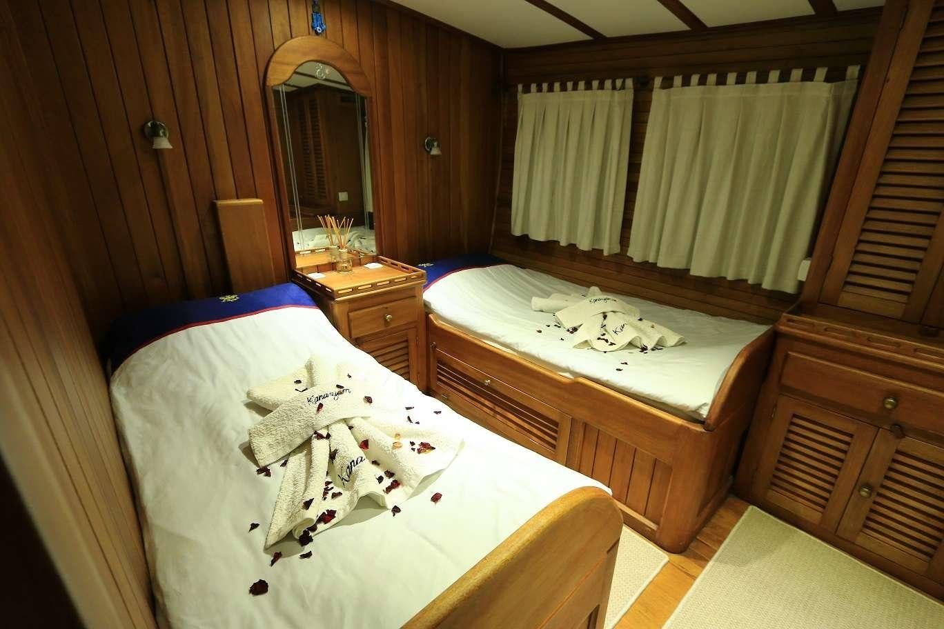 a room with a bed and a mirror aboard KANARYA Yacht for Charter