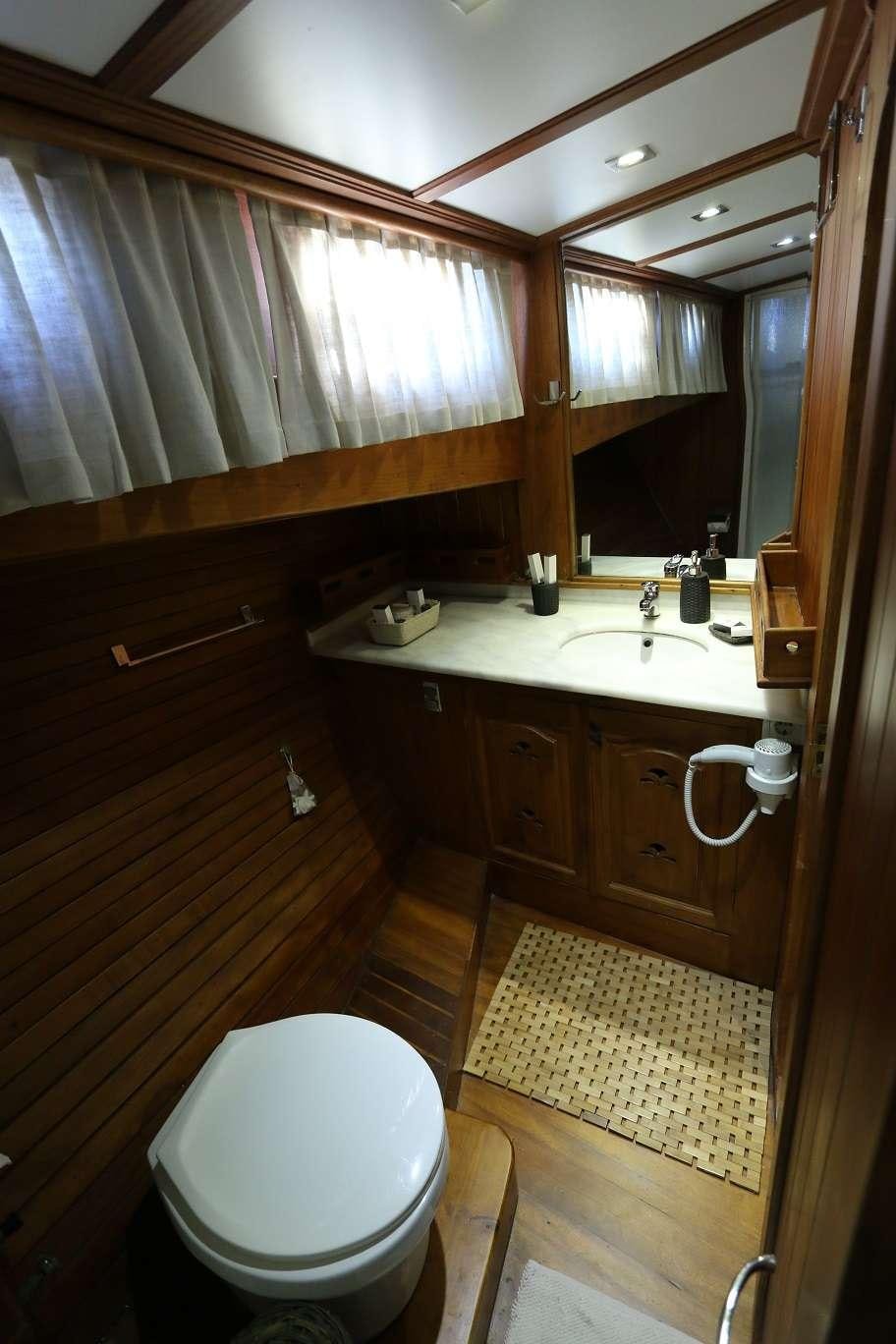 a bathroom with a toilet and a sink aboard KANARYA Yacht for Charter