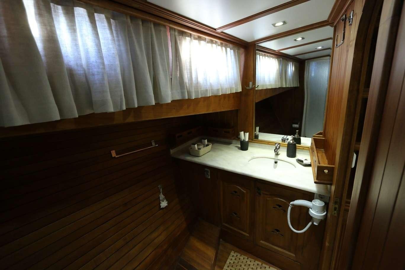 a bathroom with a sink and a mirror aboard KANARYA Yacht for Charter