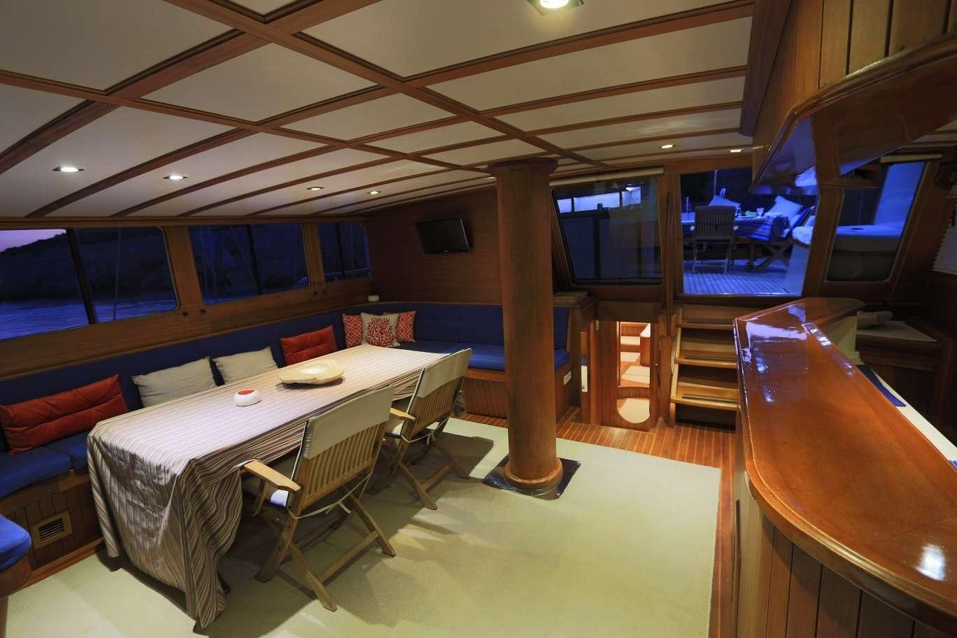 a room with a table and chairs aboard KANARYA Yacht for Charter
