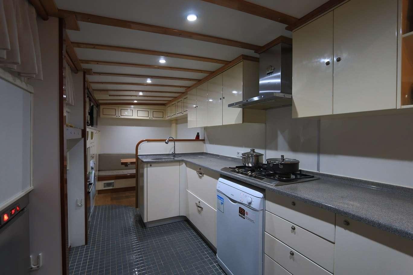 a kitchen with white cabinets aboard KANARYA Yacht for Charter