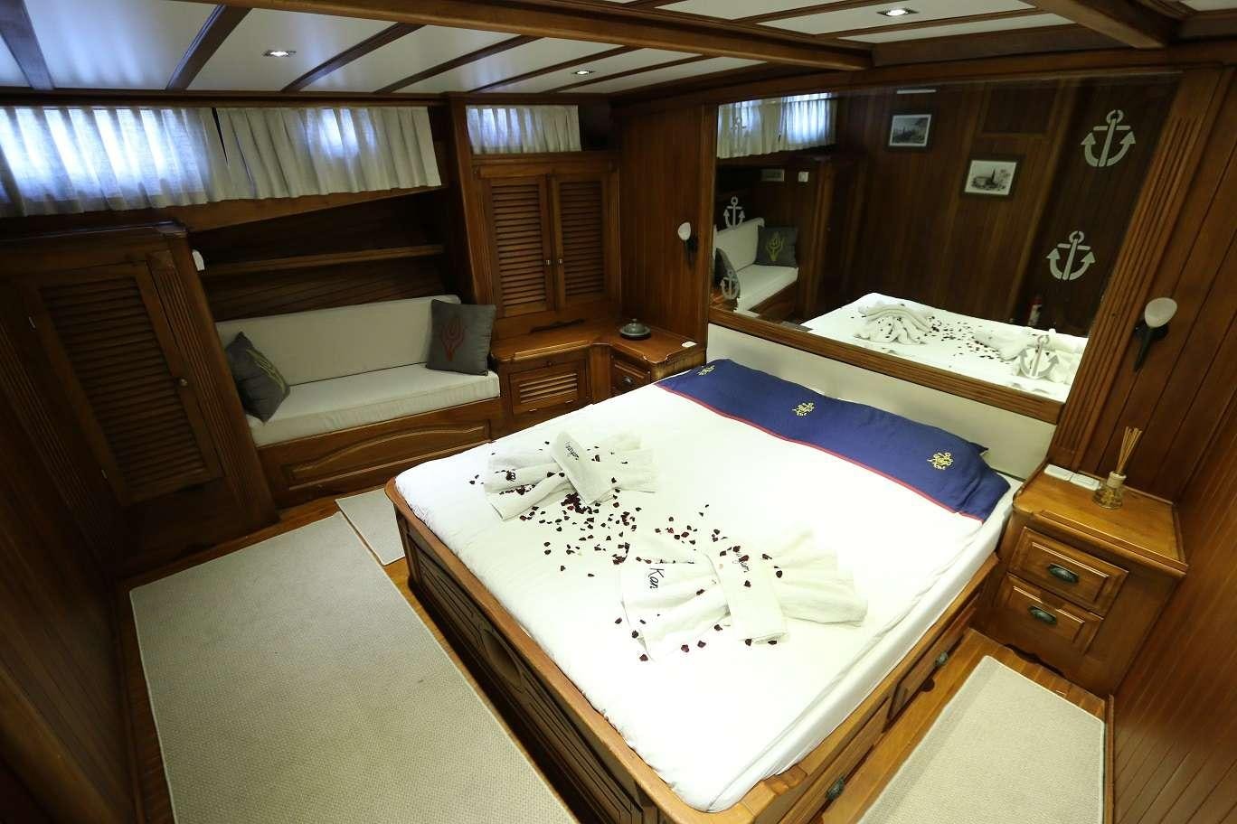 a room with a bed and a couch aboard KANARYA Yacht for Charter