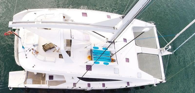a white boat with a blue seat on the front aboard KINGS RANSOM Yacht for Charter