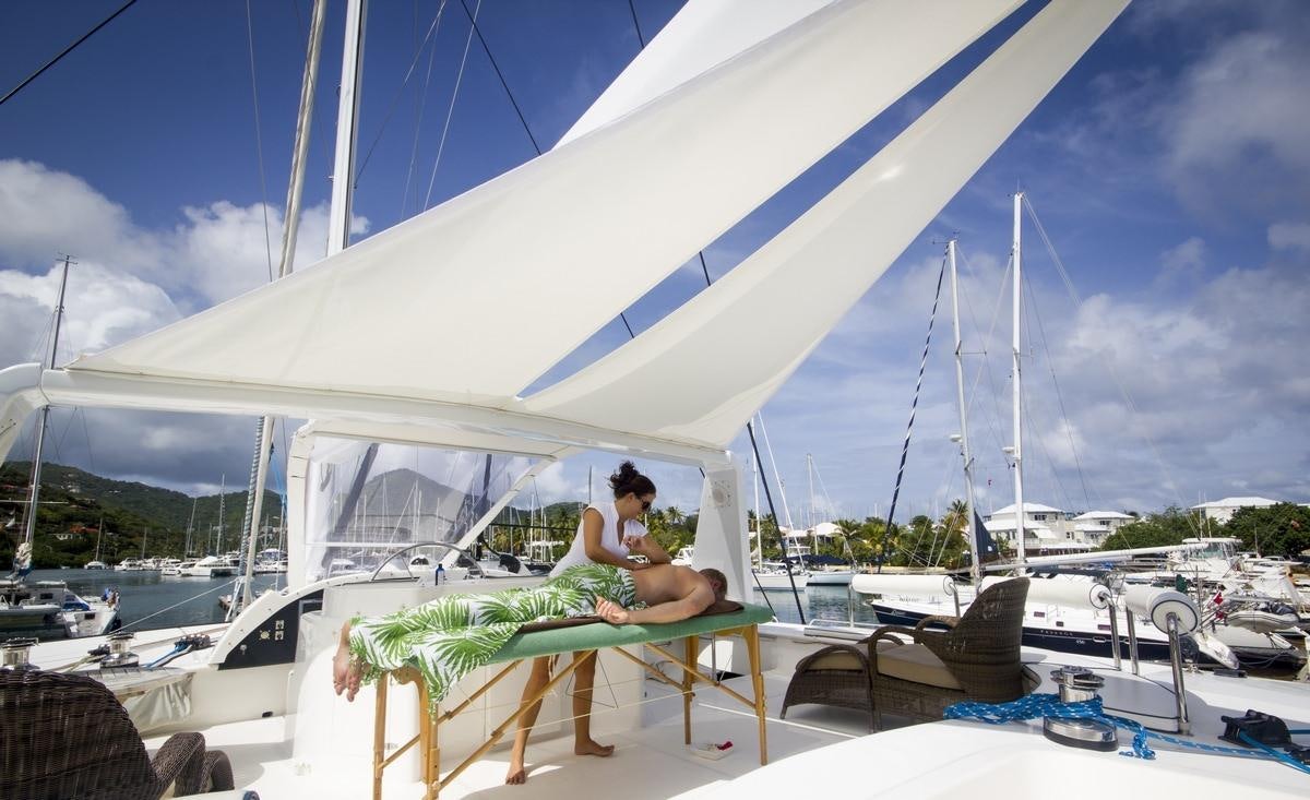 a person sitting on a chair on a boat aboard KINGS RANSOM Yacht for Charter