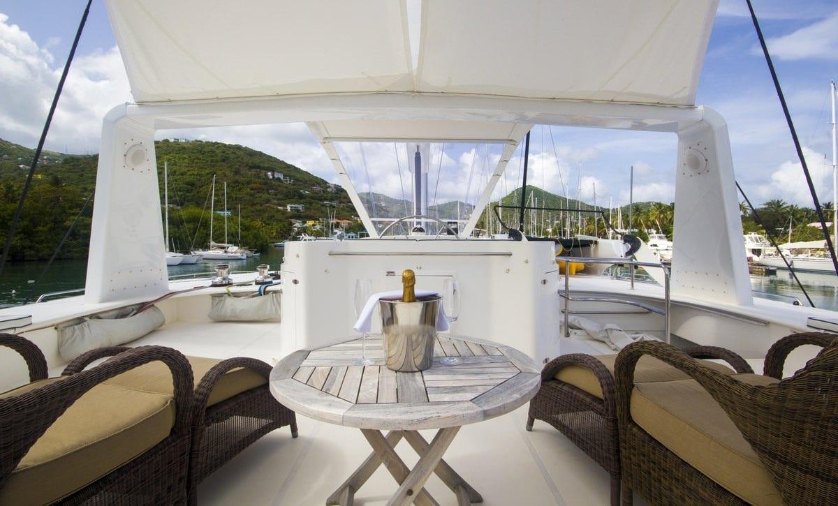 a table and chairs on a deck aboard KINGS RANSOM Yacht for Charter