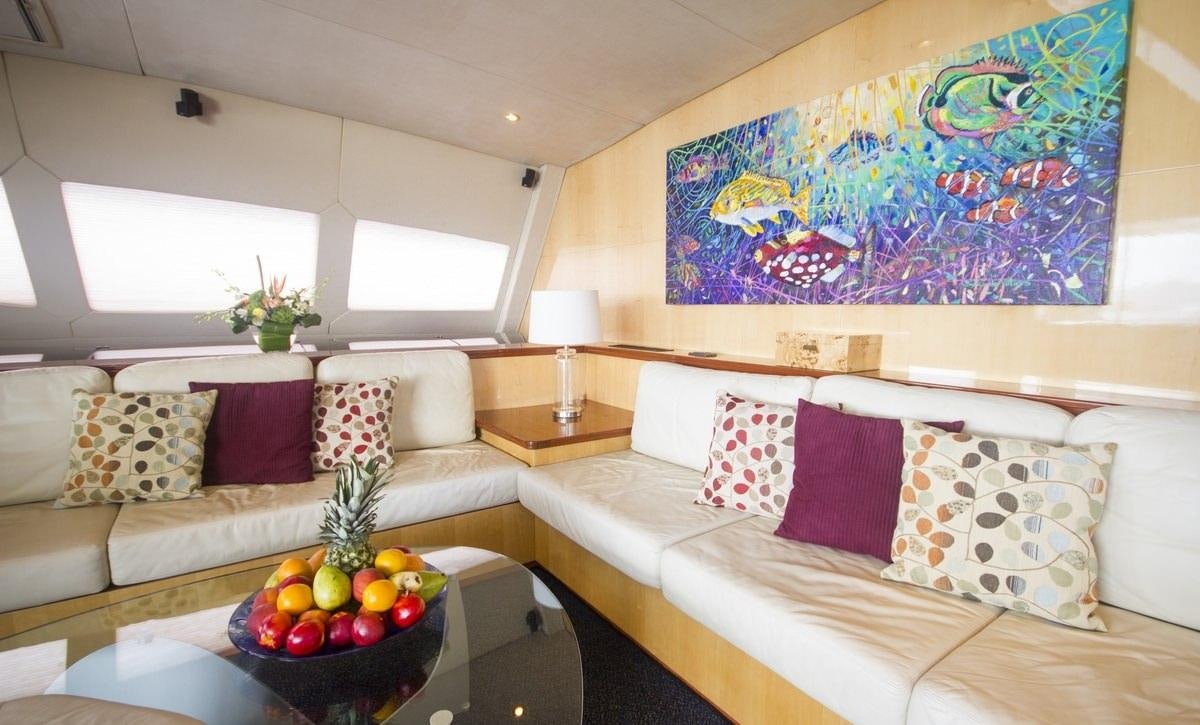 a living room with a couch and a table with fruit on it aboard KINGS RANSOM Yacht for Charter