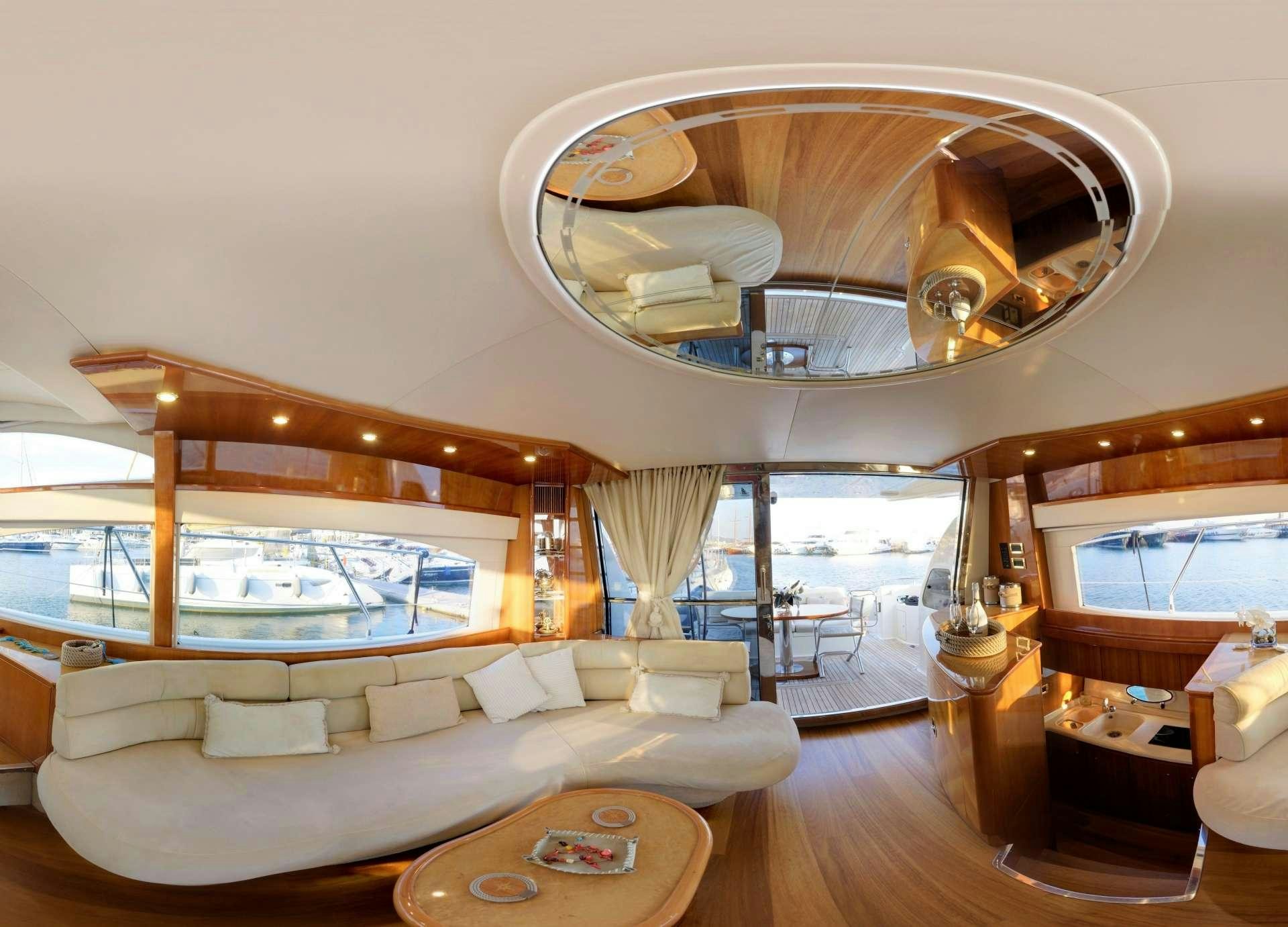 a living room with a large mirror aboard AVENTURA II Yacht for Charter