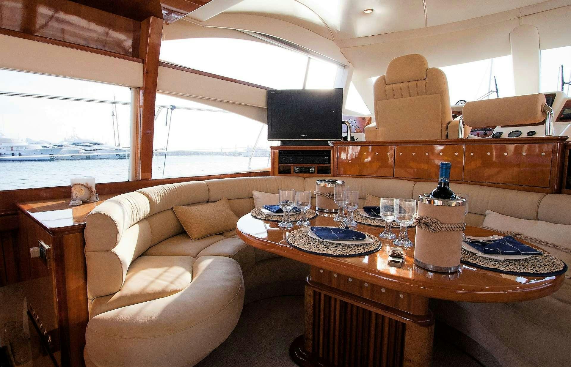 a living room with a table and chairs aboard AVENTURA II Yacht for Charter
