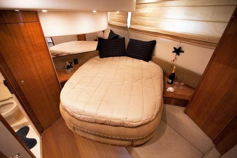 a room with a bed and a mirror aboard AVENTURA II Yacht for Charter
