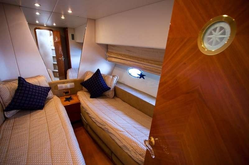a room with a bed and a mirror aboard AVENTURA II Yacht for Charter