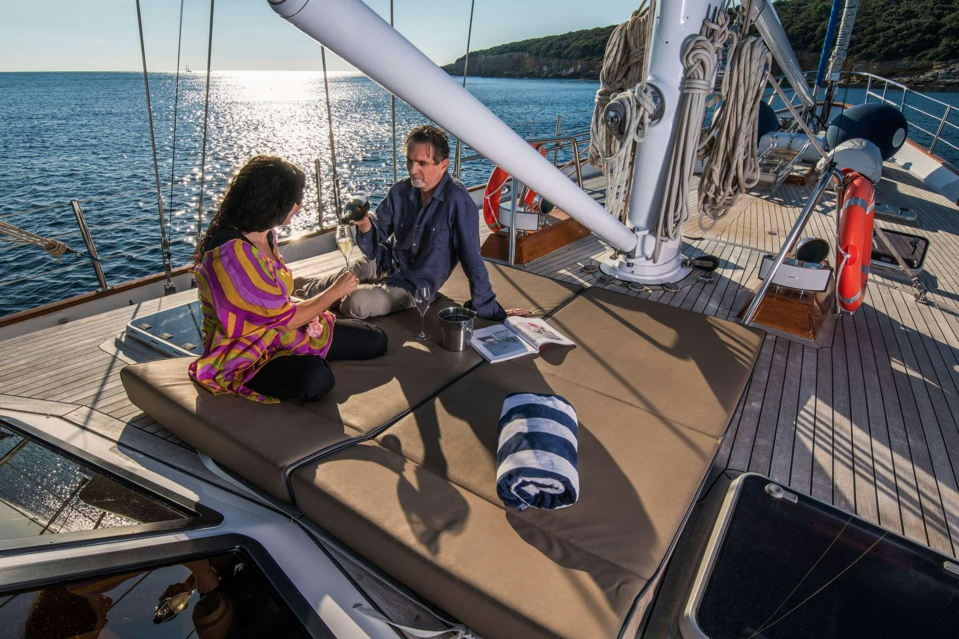 a man and woman sitting on a boat aboard Free Wings Yacht for Charter