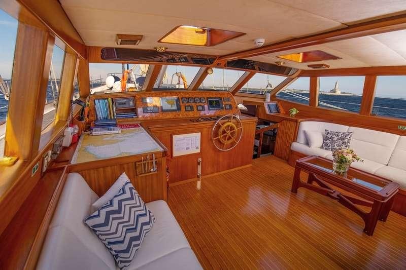 a room with a bed and a table aboard Free Wings Yacht for Charter