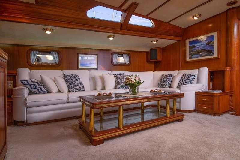 a living room with a couch and a coffee table aboard Free Wings Yacht for Charter