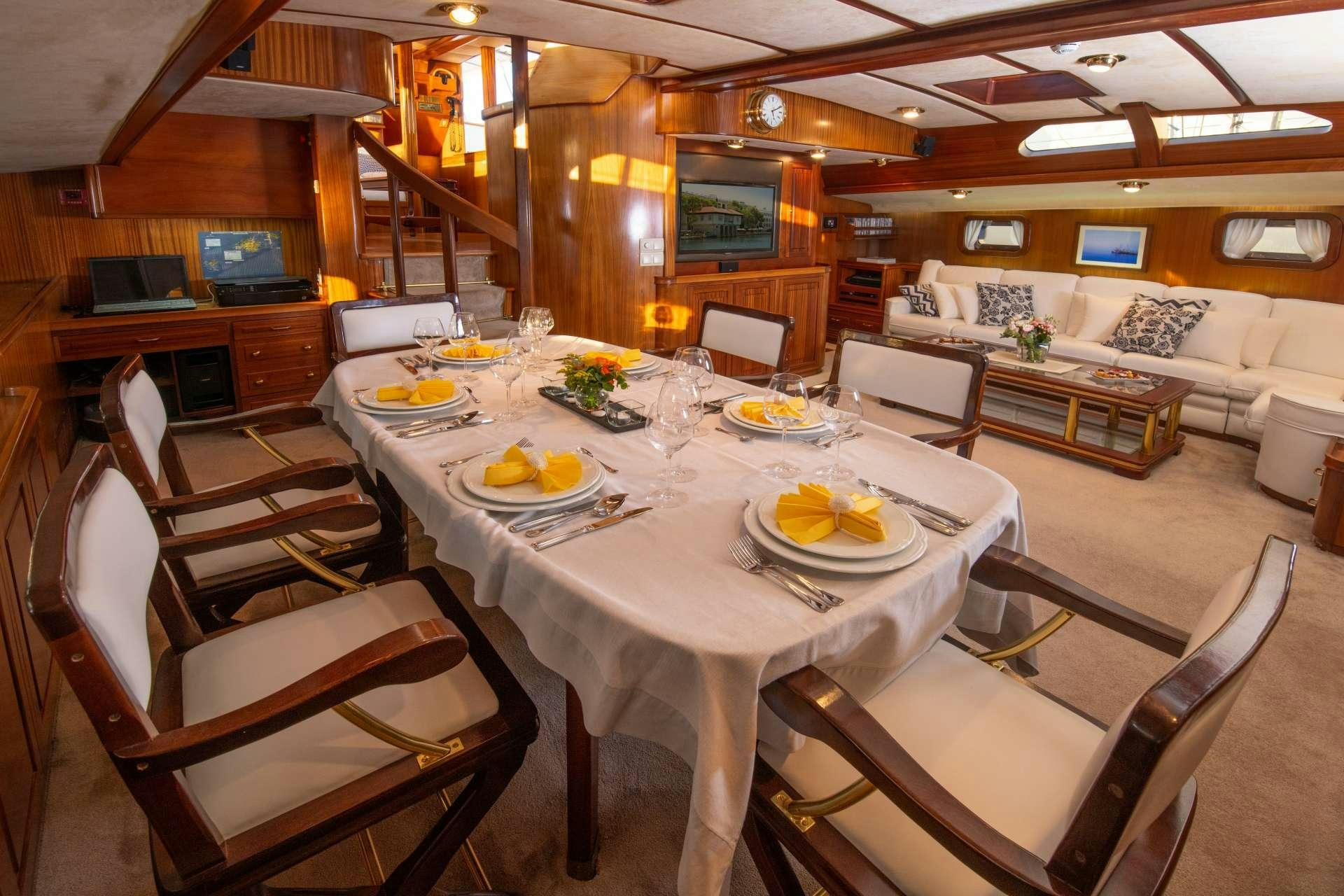 a large dining room with a table set for a meal aboard Free Wings Yacht for Charter