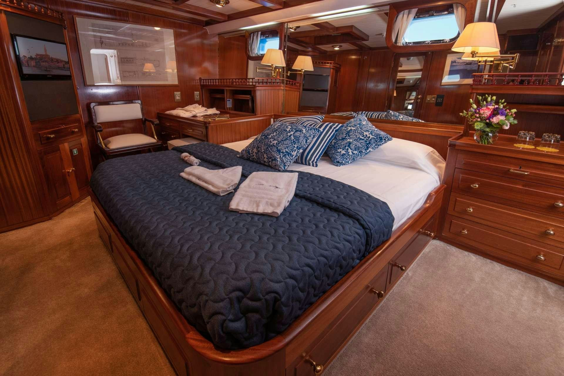 a large bed in a room aboard Free Wings Yacht for Charter