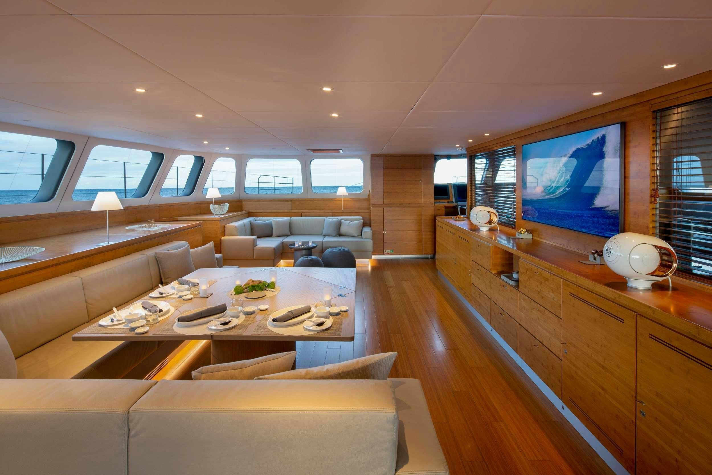 a living room with a large screen aboard CHE Yacht for Charter