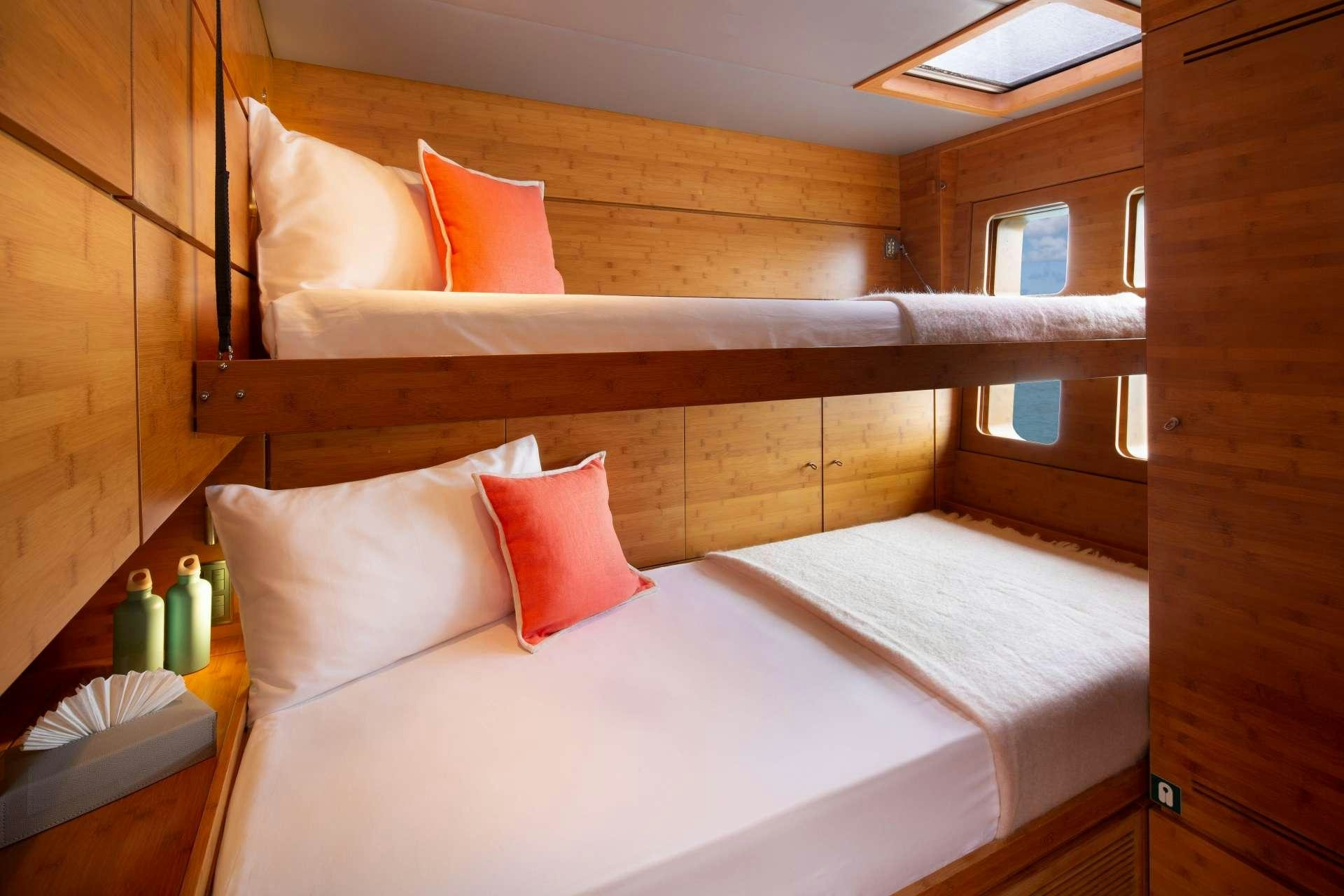 a bed with pillows on it aboard CHE Yacht for Charter