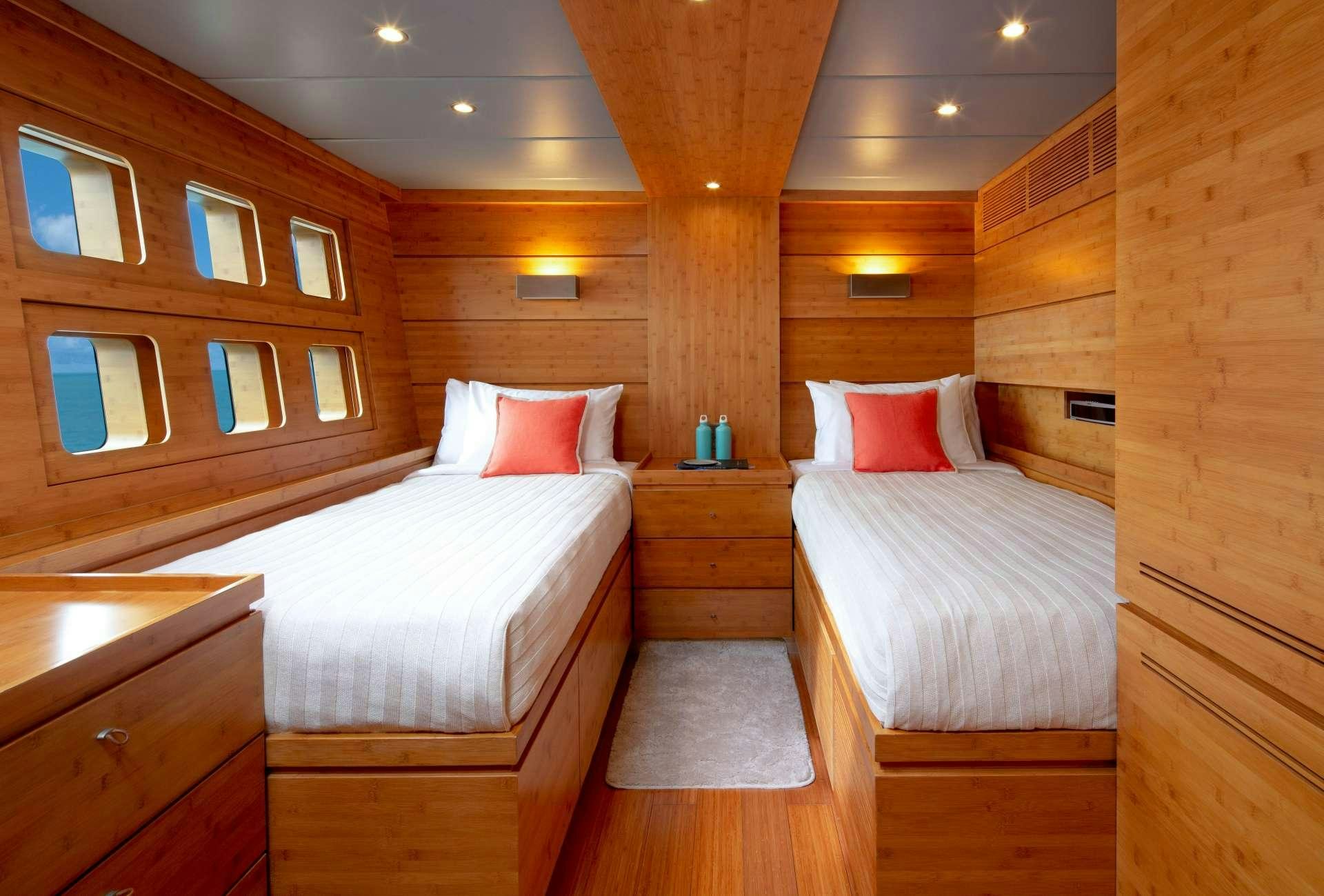 a room with two beds aboard CHE Yacht for Charter