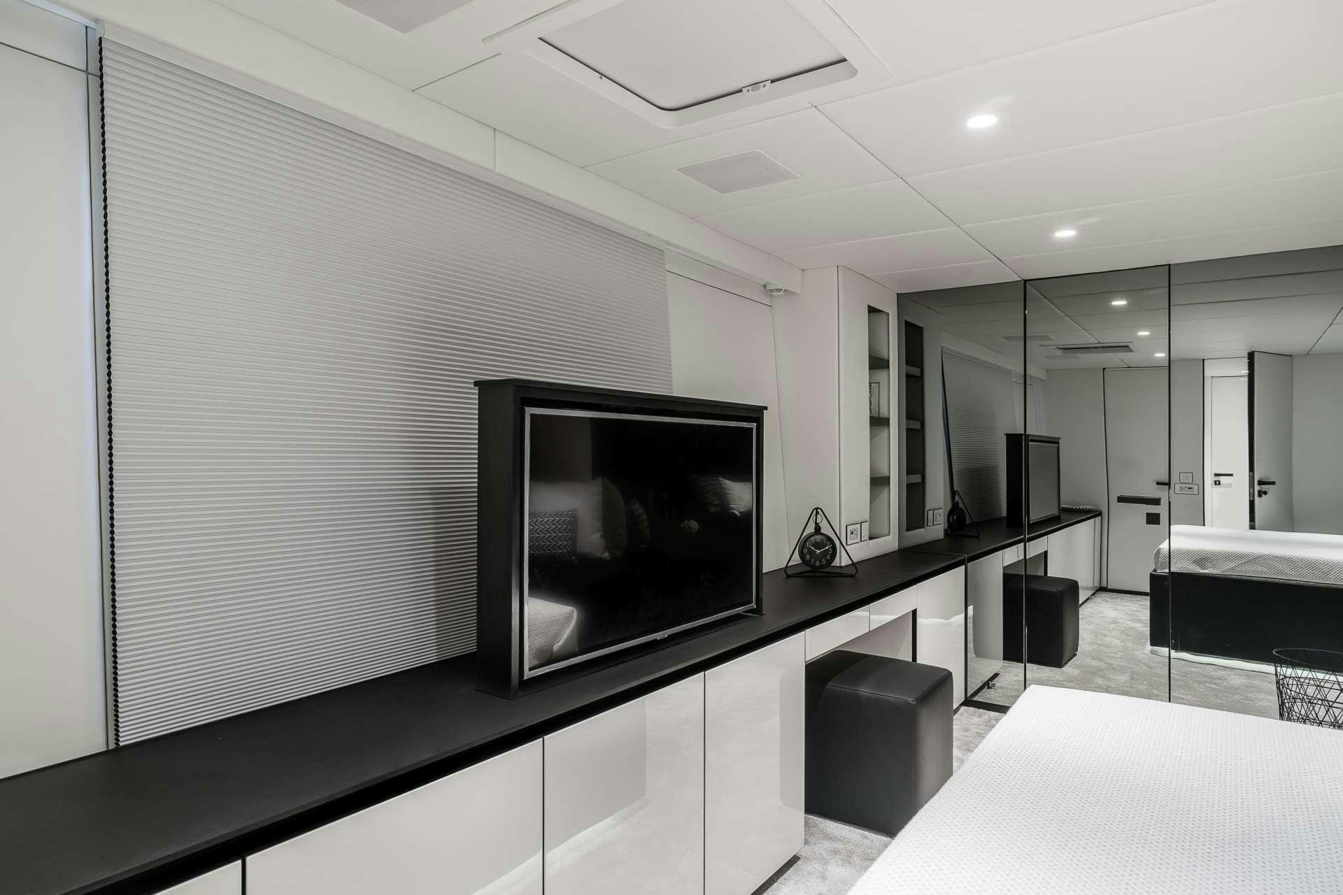 a room with a tv and a table aboard ABOVE AND BEYOND Yacht for Charter