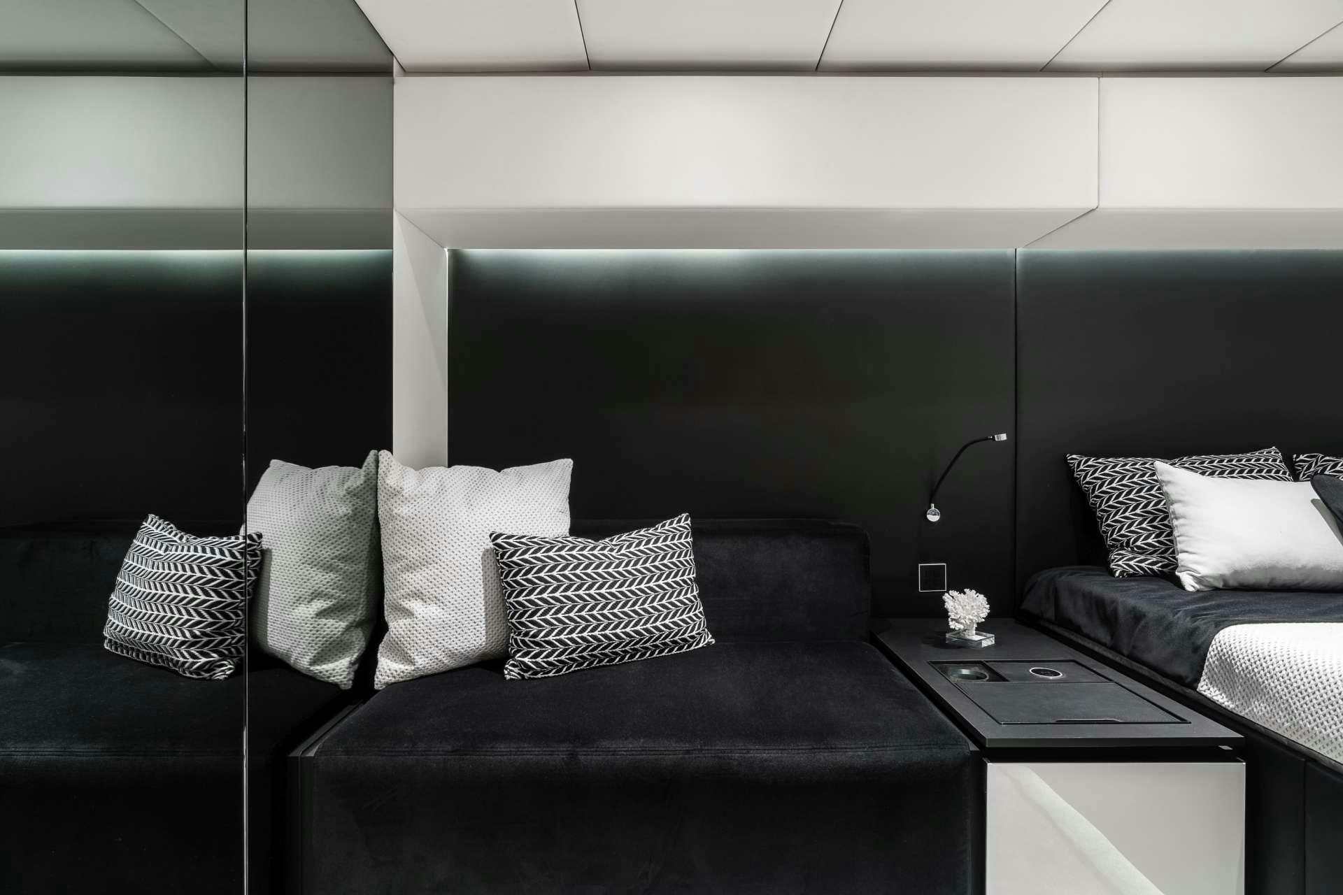 a room with a bed and a table aboard ABOVE AND BEYOND Yacht for Charter