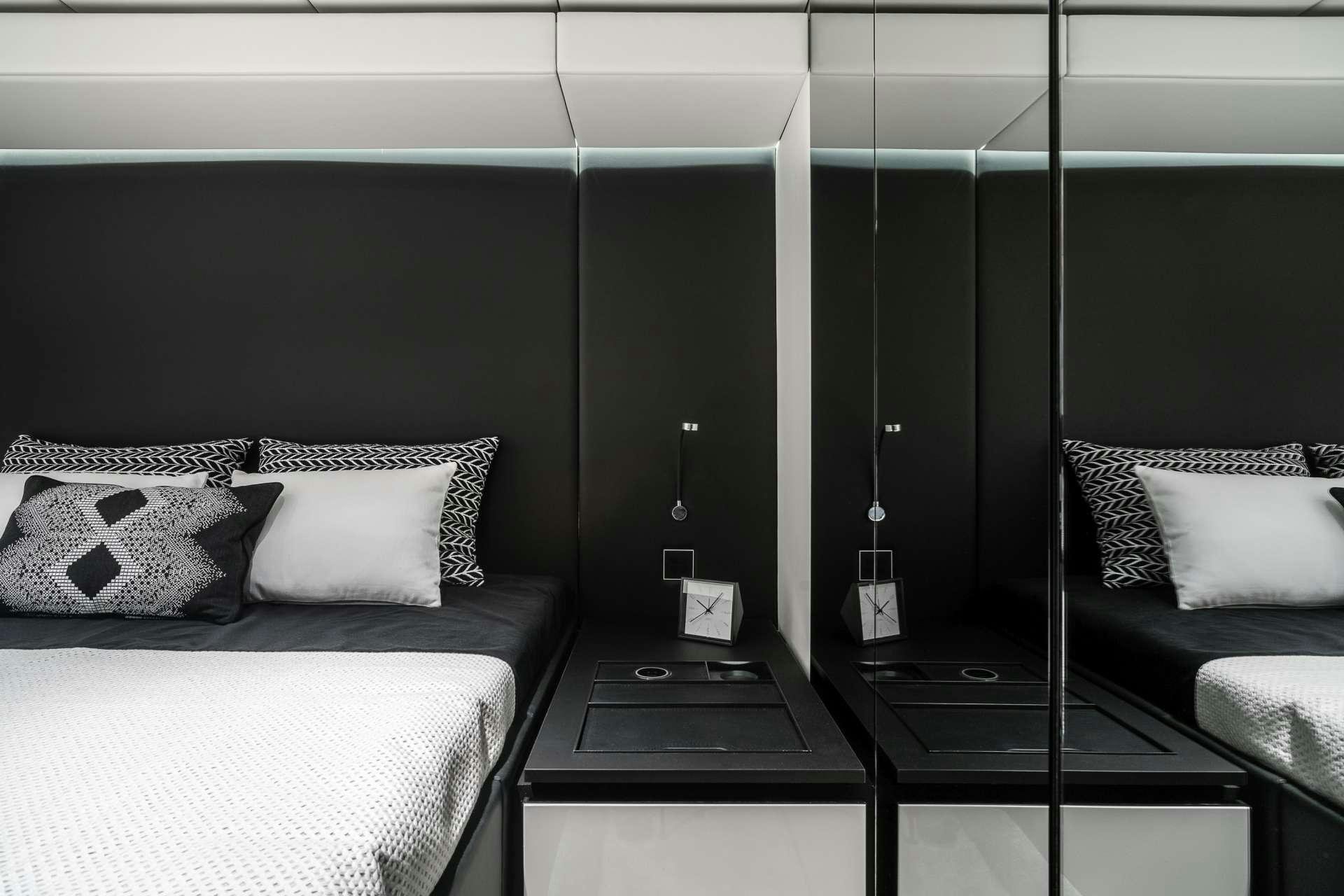 a room with a bed and a desk aboard ABOVE AND BEYOND Yacht for Charter