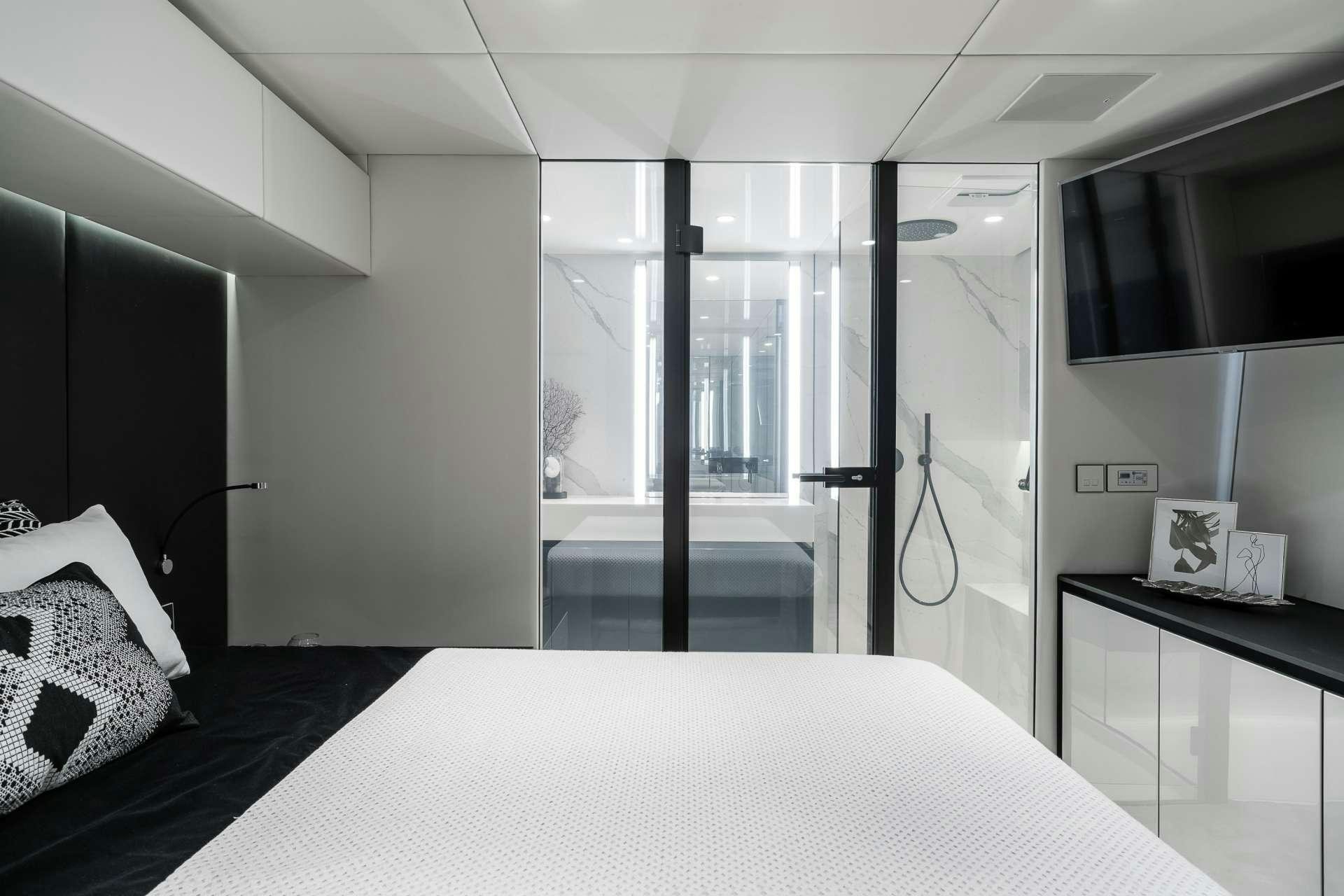 a room with a bed and a desk aboard ABOVE AND BEYOND Yacht for Charter