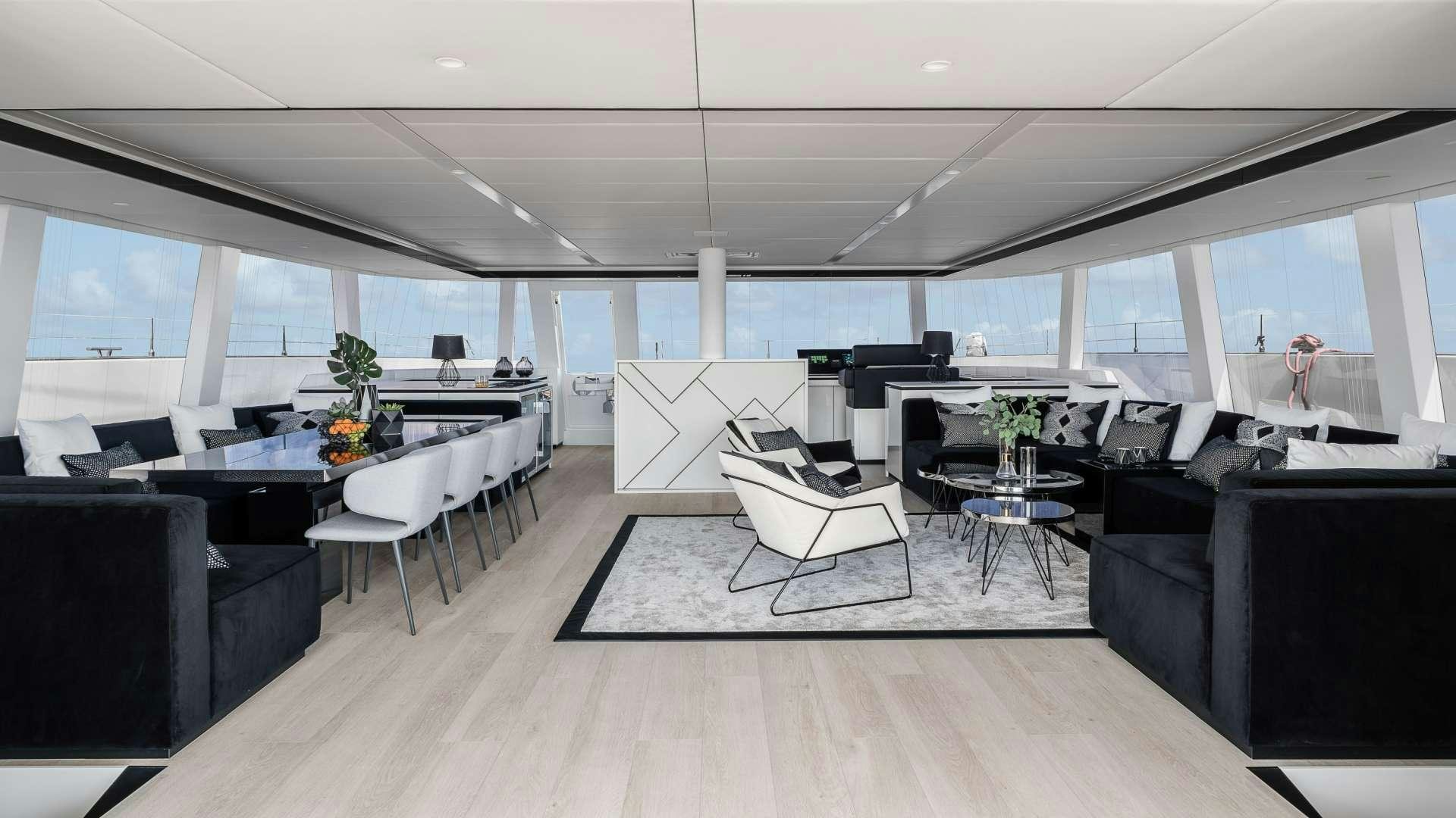 a room with a large table and chairs aboard ABOVE AND BEYOND Yacht for Charter