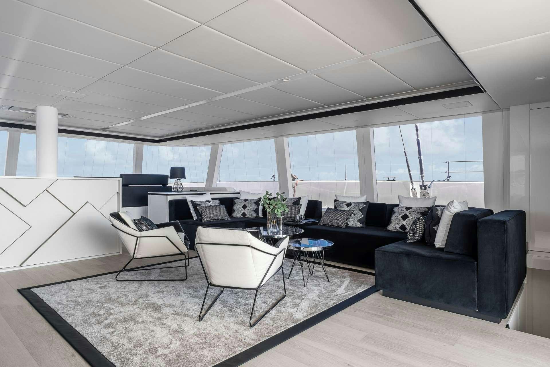 a room with a couch and a table and chairs aboard ABOVE AND BEYOND Yacht for Charter