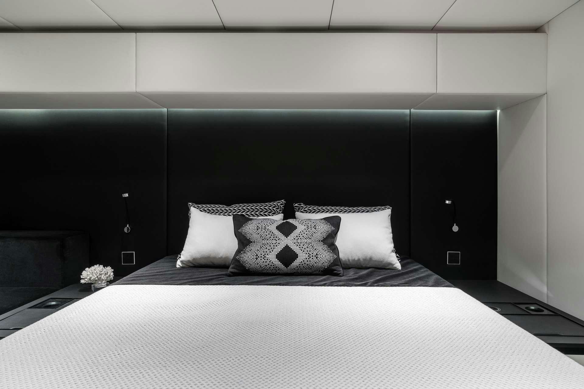 a bed with white pillows aboard ABOVE AND BEYOND Yacht for Charter