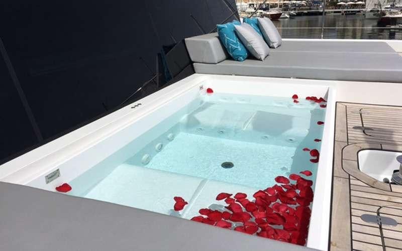 a pool with red fish in it aboard MAYRILOU Yacht for Charter