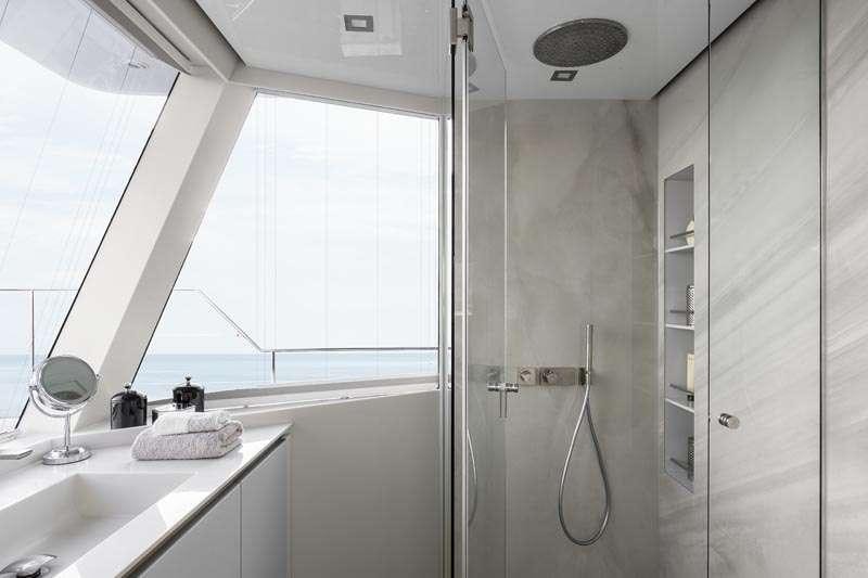 a bathroom with a shower unit and sink aboard MAYRILOU Yacht for Charter