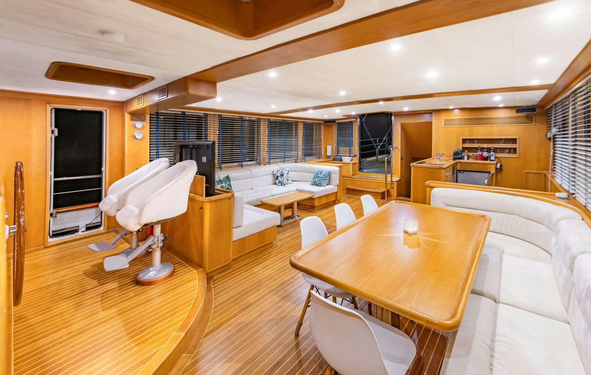 a room with a table and chairs aboard VIVA SHIRA Yacht for Charter