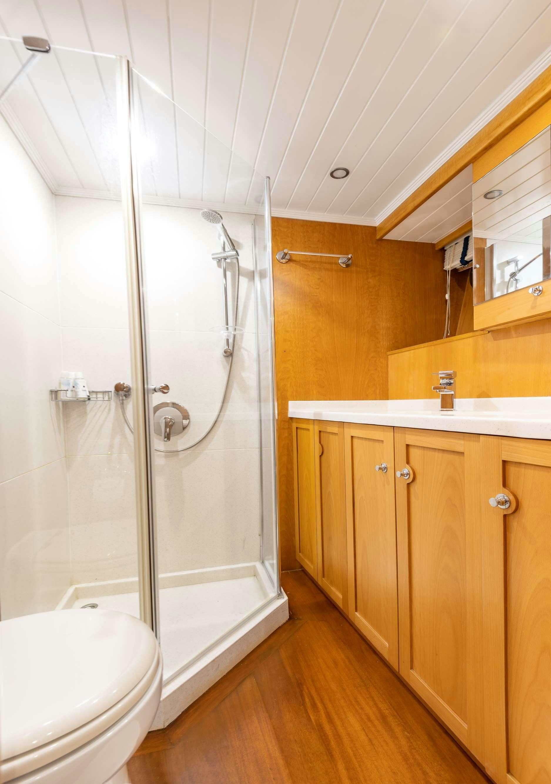 a bathroom with a shower unit and a toilet aboard VIVA SHIRA Yacht for Charter