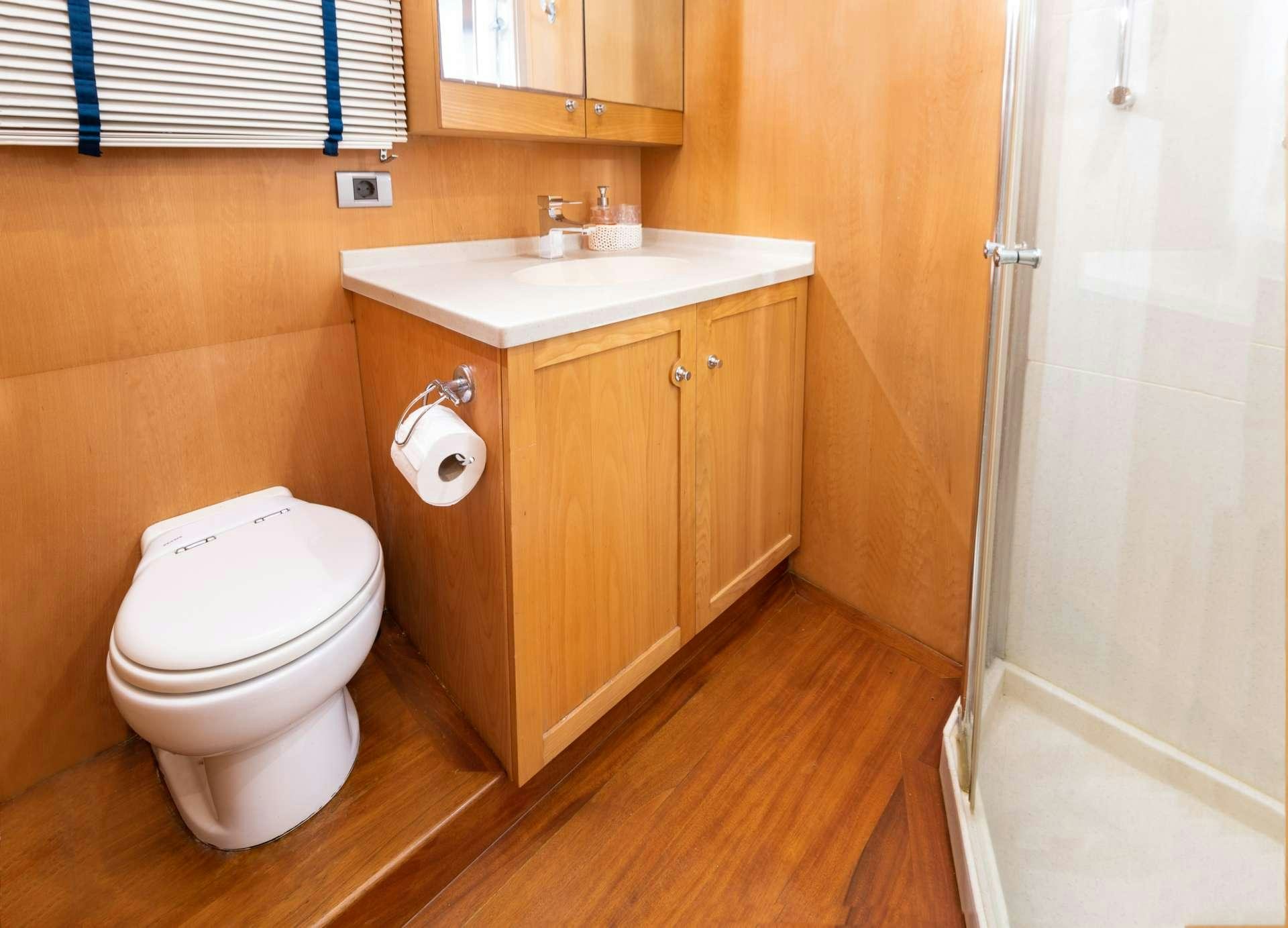 a bathroom with a toilet and sink aboard VIVA SHIRA Yacht for Charter