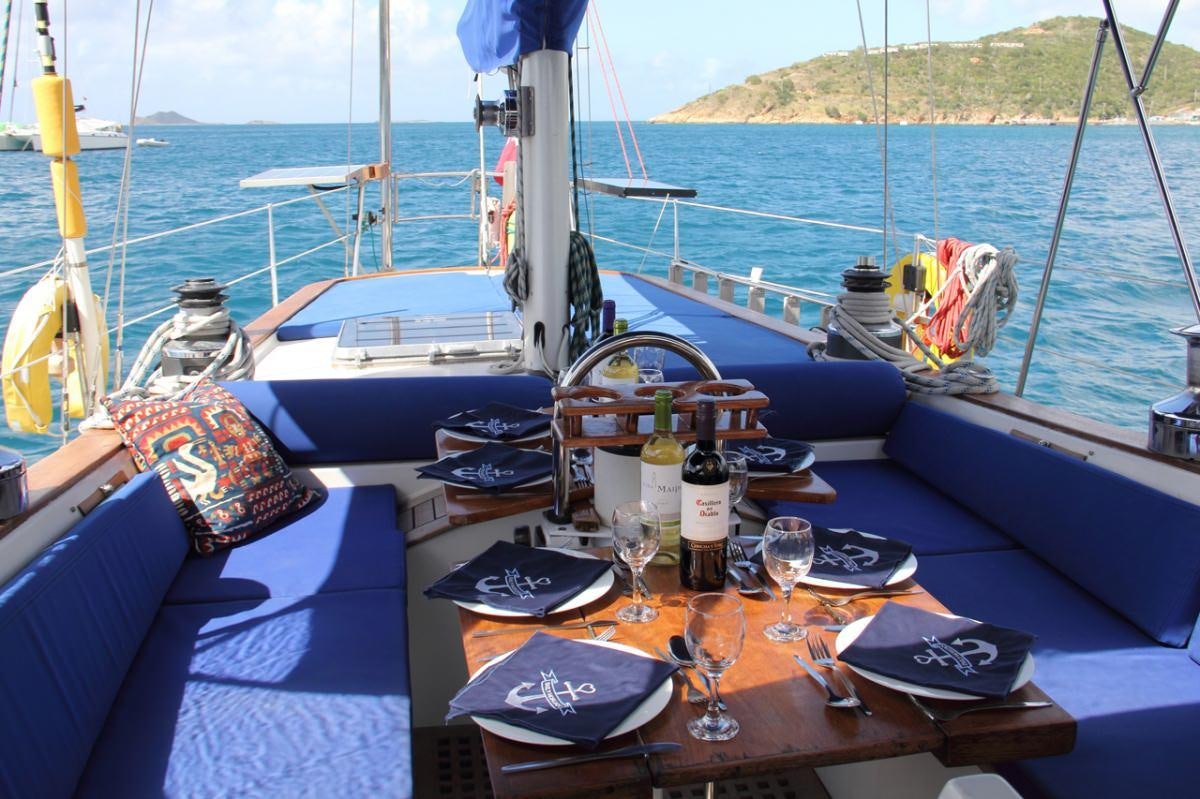 a table with a bottle and a plate on it aboard EMILY MORGAN Yacht for Charter