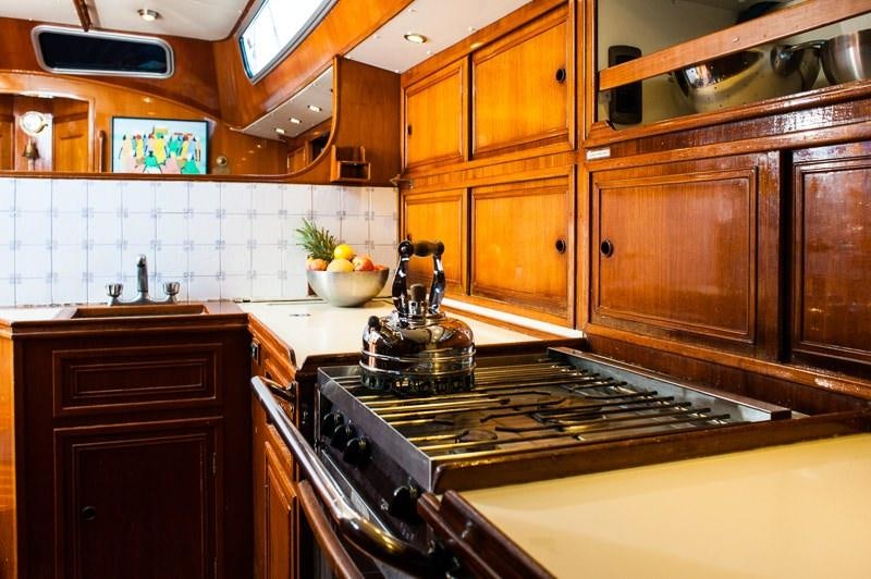 a kitchen with wooden cabinets aboard EMILY MORGAN Yacht for Charter