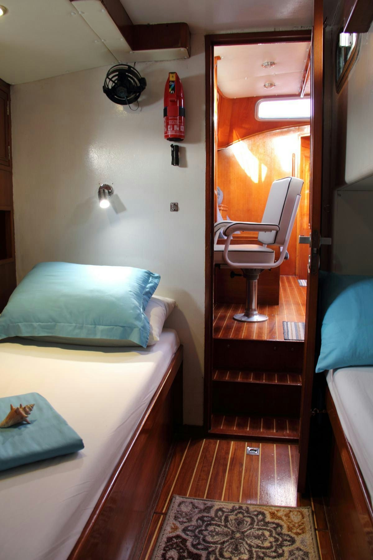 a room with a bed and a chair aboard EMILY MORGAN Yacht for Charter